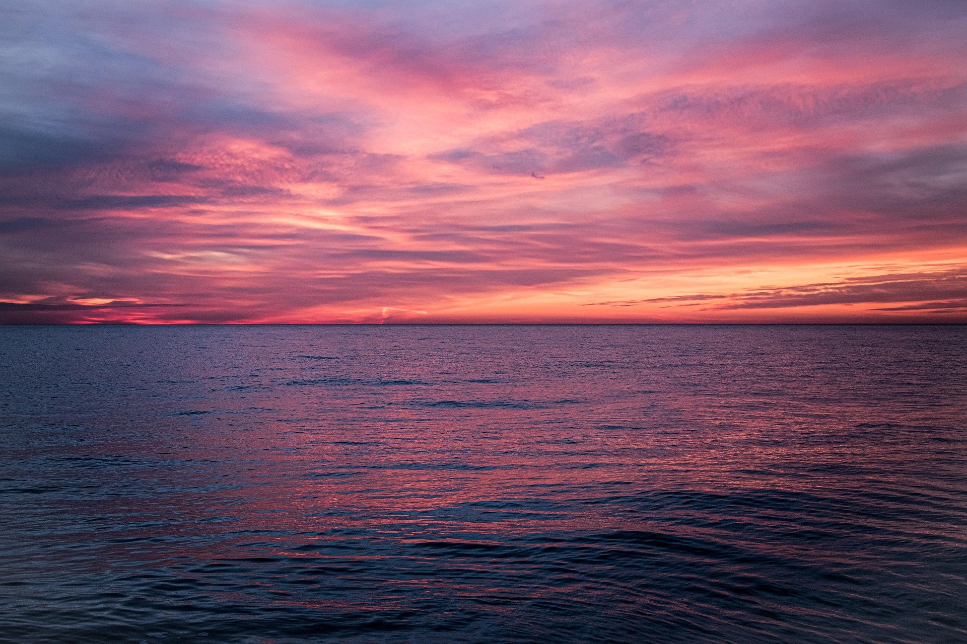 Romantic pink sunset over the ocean for honeymoon couples
