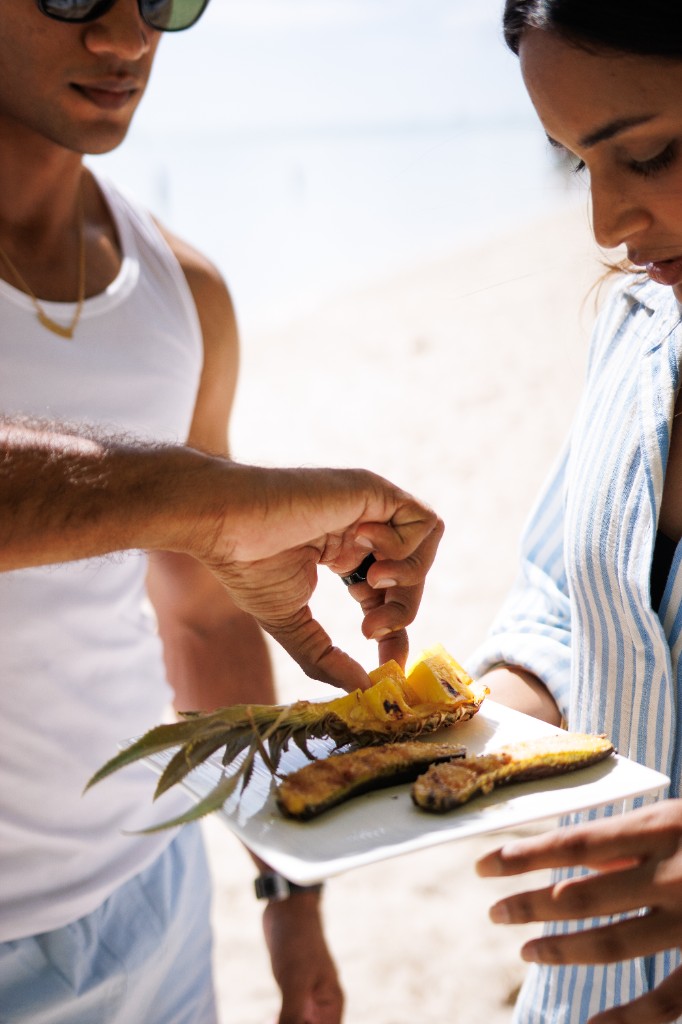 Grilled pineapple and banana dessert shared on the beach